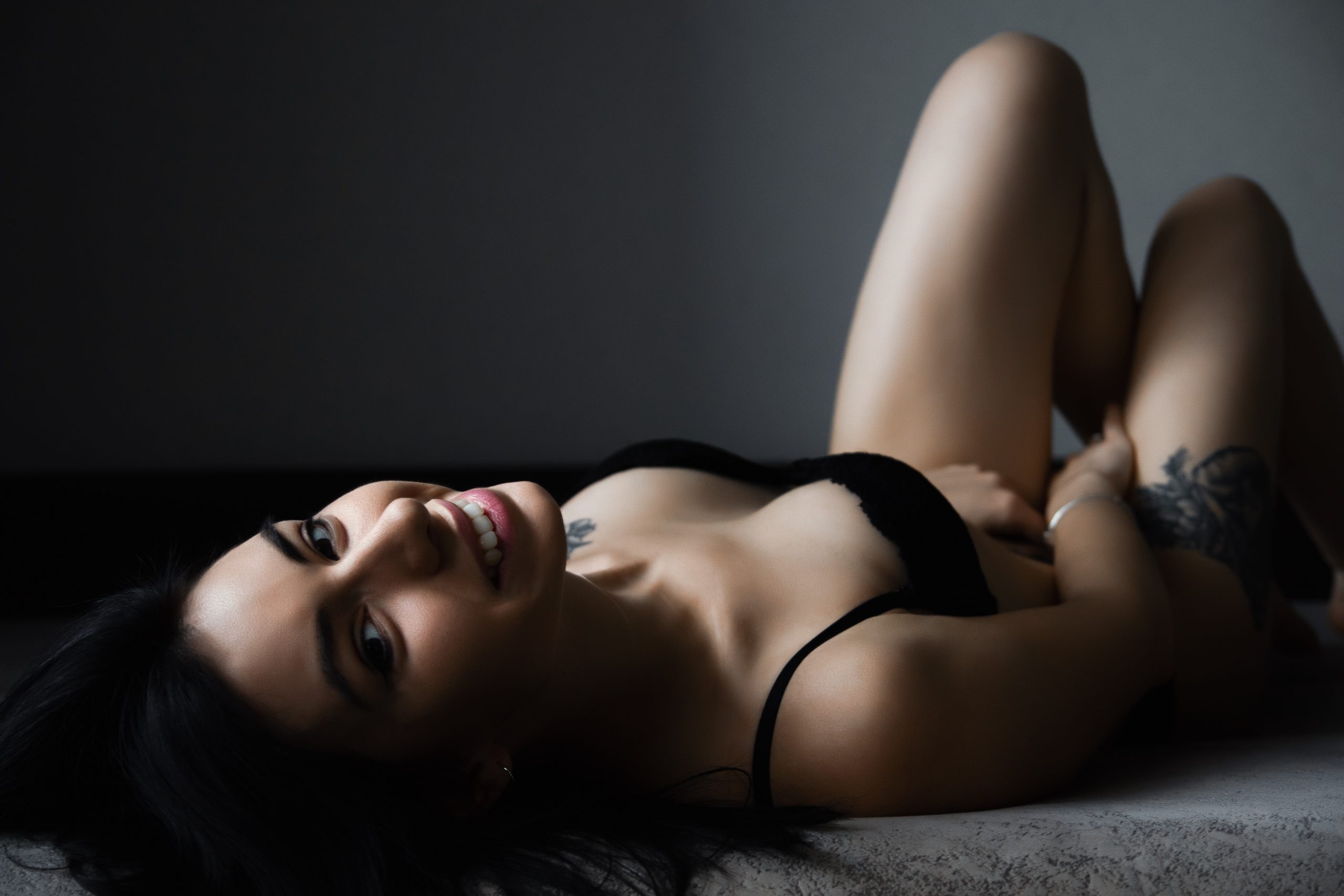 Girl in bed in black lingerie